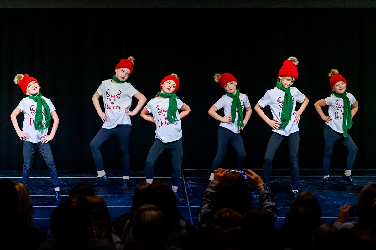 Children on stage with scarves