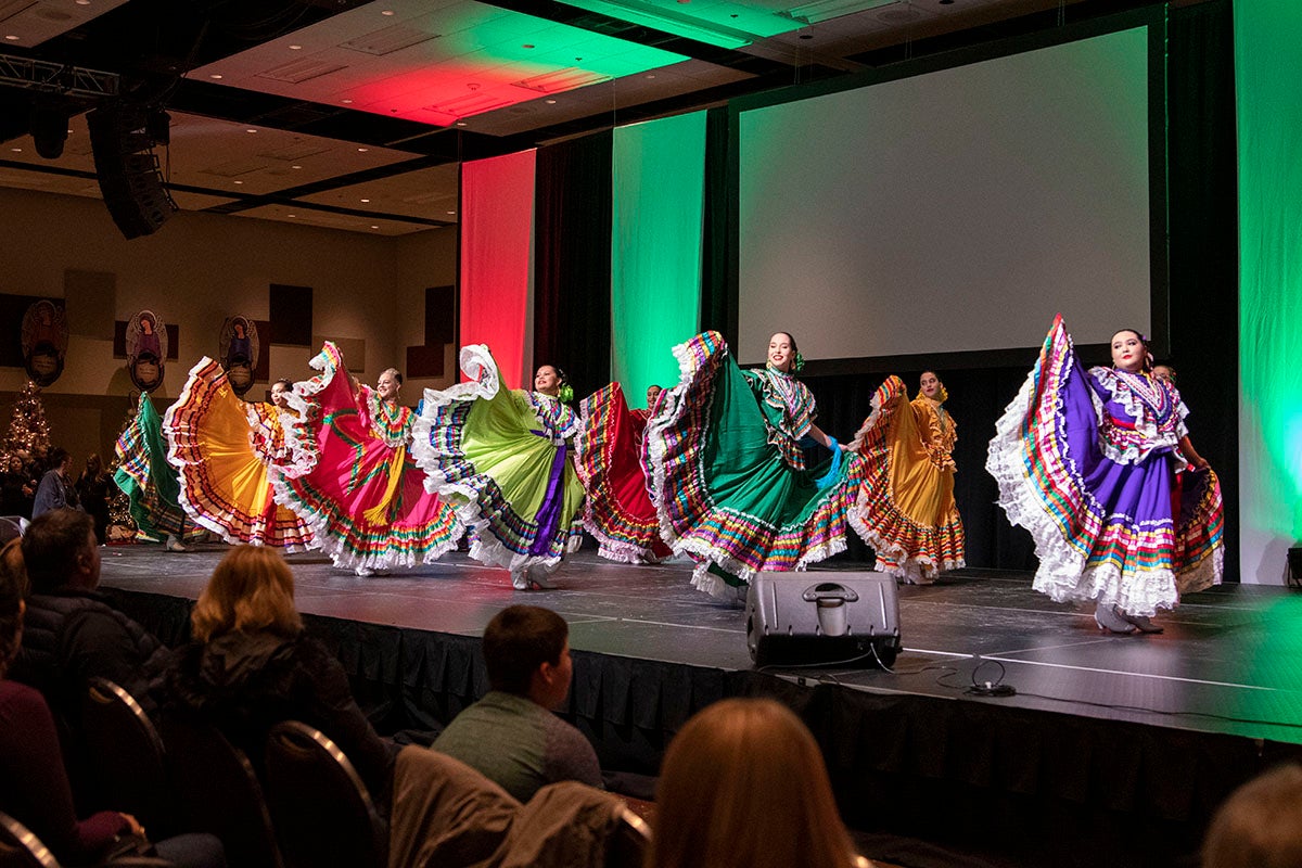 People on stage in traditional dresses