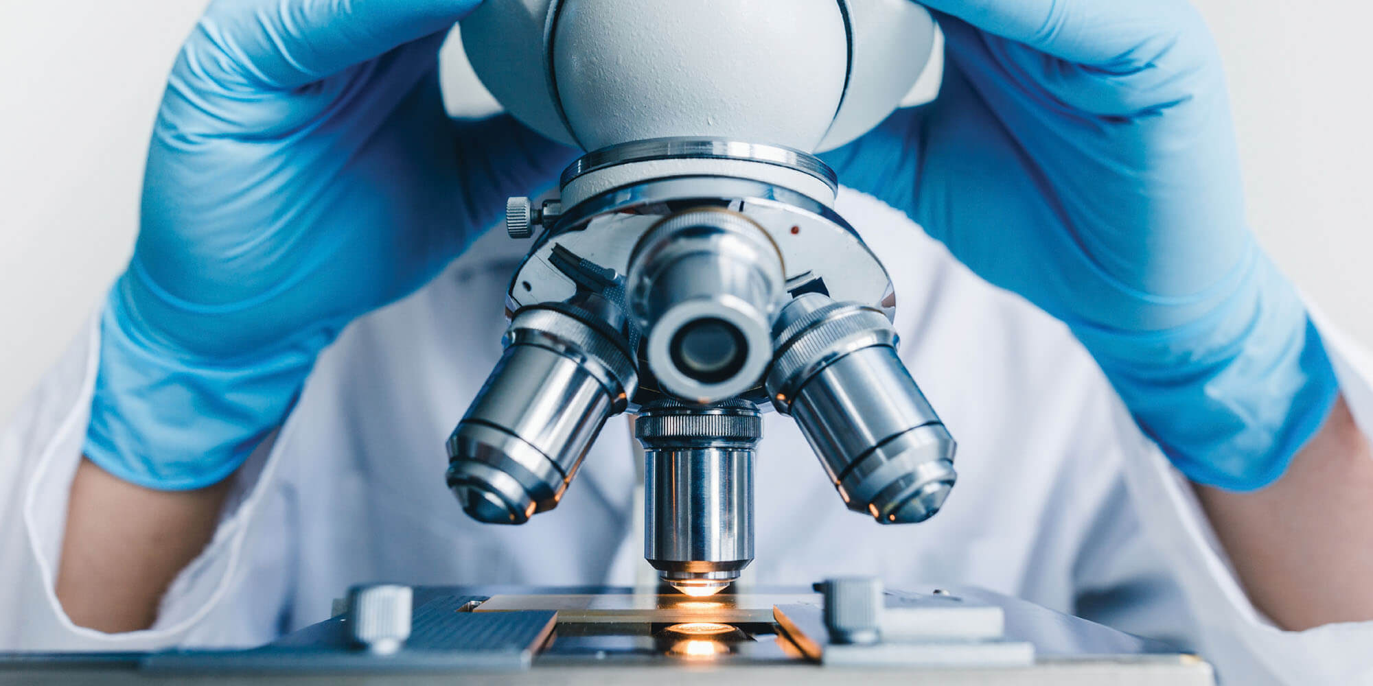 Provider looking into microscope